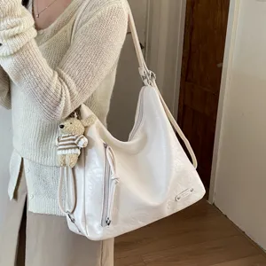 Large capacity women shoulder hobo bag with cute bear pendant and soft leather material.