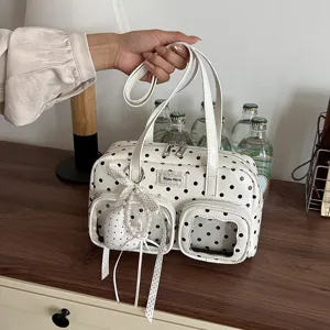 White polka dot bowling handbag with transparent pockets, stylish shoulder bag for women daily commute.