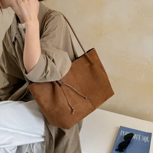 Brown suede tote bag for women, large capacity retro casual shoulder bag with drawstring detail.