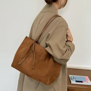 Chic brown suede tote bag for women, featuring a stylish front knot detail and roomy design.