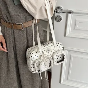 White polka dot bowling shoulder bag detail shot, PU leather daily commuter handbag with pockets.