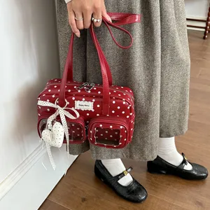 Red polka dot bowling handbag detail, clear front pockets, cute ribbon heart charm.