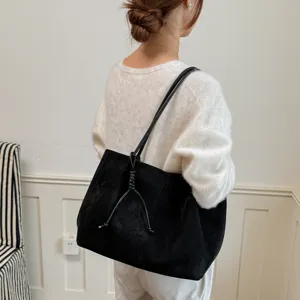 Large capacity commuter shoulder bag for women, retro black suede tote bag with stylish knot design.