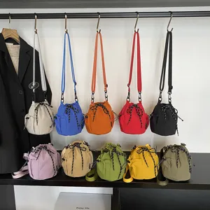 Detailed view showcasing multiple colorful nylon drawstring bucket bags hanging and displayed nicely.