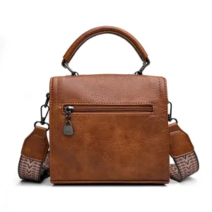 Sac a main vintage en cuir synthetique marron avec detail poche arriere et bandouliere.