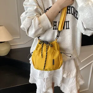 Stylish nylon drawstring bucket crossbody bag with mesh pockets, perfect for casual outdoor use.