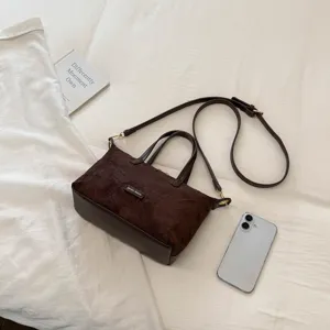 Vintage brown suede handbag for women, casual crossbody bag with top handle and strap.
