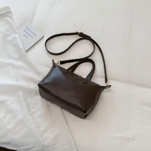 Detailed view of the dark brown minimalist suede women handbag, showcasing fine texture and hardware.