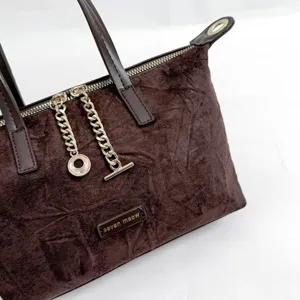 Dark brown suede handbag for women, vintage solid color crossbody bag with chic chain detail.