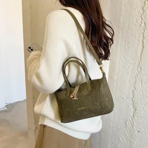 Retro olive green suede handbag for women, versatile stylish crossbody bag with chain pendant.