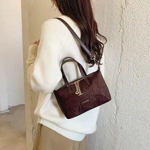 Classic brown faux suede handbag for women, retro casual shoulder bag with metal charm.