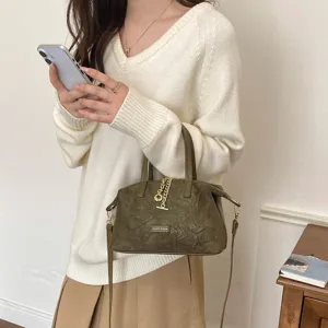Minimalist retro dark green suede handbag with metal chain detail and crossbody strap for women.