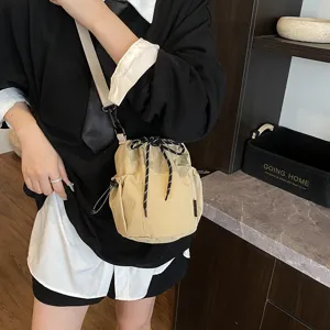 Detailed view of the stylish nylon bucket crossbody bag with convenient drawstring closure.