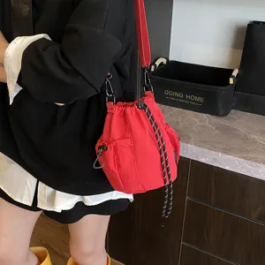 Detailed view of red nylon bucket bag with drawstring, casual style daily crossbody.