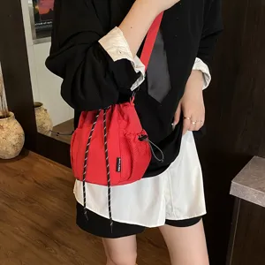 Japanese ins style nylon crossbody bag, casual drawstring bucket bag with mesh pockets.