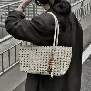 Woven hollow tote bag for women, stylish summer shoulder bag with beads pendant for commute.