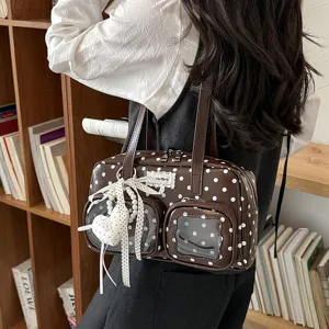 Brown polka dot shoulder bag with clear front pocket, elegant ribbon and pearl charm for women.