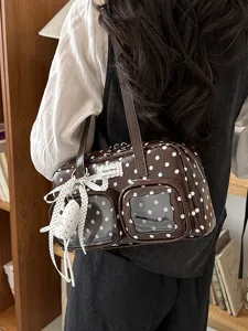 Brown polka dot bowling shoulder bag with clear front pockets, stylish commuter handbag.