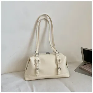 Detailed view of the off-white shoulder bag with double buckle straps in a minimalist scene.
