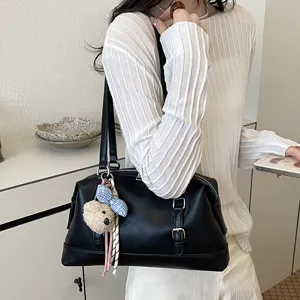 Detailed shot of retro black PU leather shoulder bag, large capacity commuting tote.