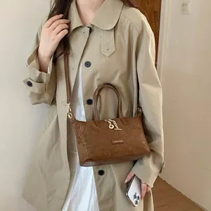 Classic vintage suede crossbody bag for women, stylish small tote with metal chain charm.