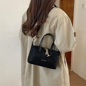 Minimalist black suede handbag for women, chic vintage crossbody bag with top handle and metal chain.