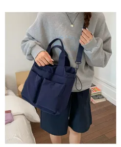 Korean style multi-pocket canvas shoulder bag, casual commuter tote and crossbody design.