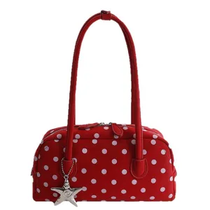Stylish red polka dot bowling shoulder bag for women, trendy daily commuting pillow handbag.