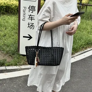 Large capacity women's woven tote bag, stylish hollow summer shoulder bag for daily commute.