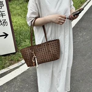 Woven tote bag for women, stylish hollow out design with cute bead pendant, perfect summer handbag.