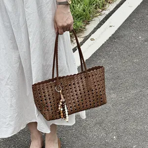 Large capacity woven tote bag for women, stylish cutout summer commuter shoulder bag.