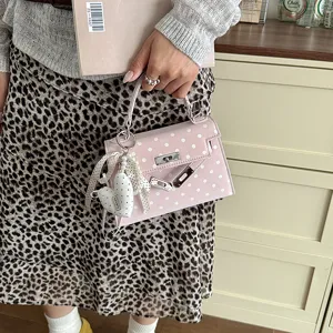 Pink polka dot mini handbag for women, cute shoulder crossbody bag with pearl heart charm.