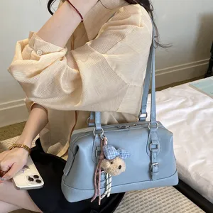 Classic retro blue underarm shoulder bag detail showing stylish daily commuting look.