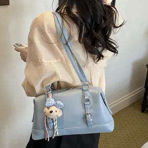 Vintage light blue underarm shoulder bag detail showing premium PU leather and cute bear charm.