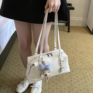 Minimalist white faux leather shoulder bag for women, retro casual commuter handbag with charm.