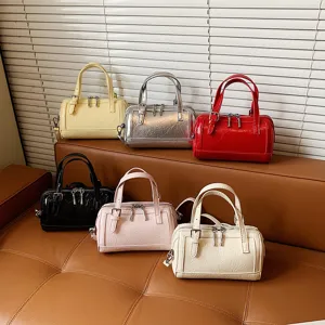 Close-up of multiple stylish mini bowling bags in assorted colors displayed on leather.