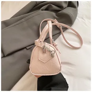Pink mini Boston handbag detail view, showing soft PU leather material, smooth zipper and straps.