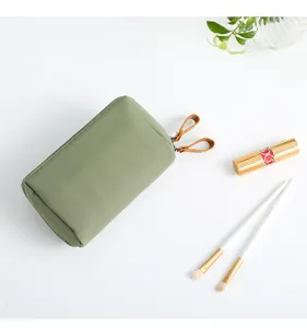 Green minimalist portable cosmetic bag, small travel makeup pouch with zipper and leather pull.