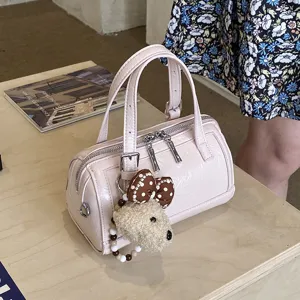 Pink patent leather Boston bag with cute fluffy dog pendant, stylish casual handbag for women.