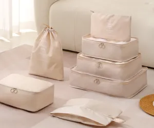 Beige travel packing cubes set, multiple mesh organizer bags for luggage clothes and shoes.