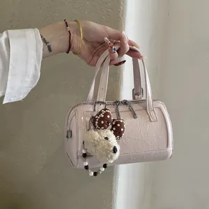 Chic pink patent leather Boston pillow bag, stylish daily handheld purse with cute puppy charm.