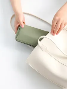 Portable mini cosmetic bag for women, simple solid color makeup organizer for travel use.