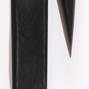 Detailed shot of the black cosmetic bag zipper pull and leather texture minimalist style.