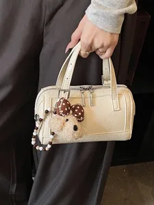 Chic minimalist off-white boston pillow handbag for women with cute puppy charm. Stylish daily use.