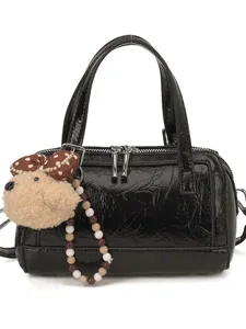 Black patent leather boston bag for women, stylish handbag with cute puppy plush charm.