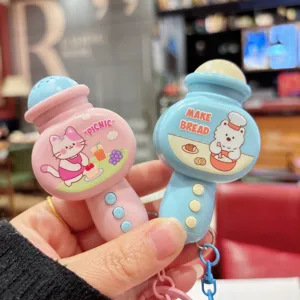 Close-up view of cute cartoon mini microphone keychains with adorable cat and bear graphic designs.