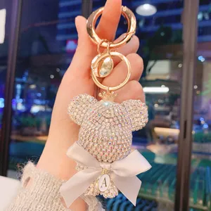 Rhinestone bear keychain with bow and letter A pendant, cute sparkling car key ring bag charm for women.