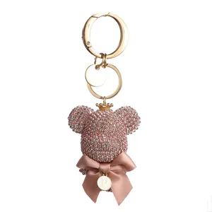 Pink rhinestone bear keychain with crown, bow and letter P charm for women bags and keys.