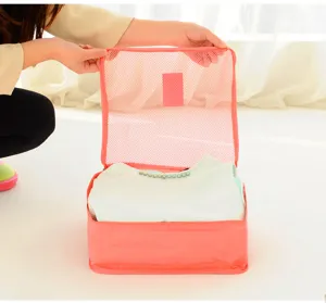 Pink mesh travel packing cube for clothes organization in luggage, showing open compartment detail.