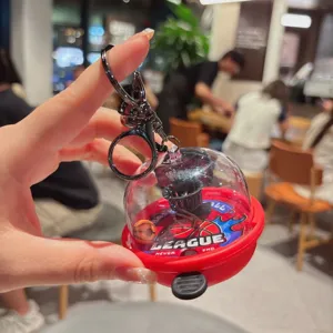 Close-up detail view of a creative mini basketball hoop keychain toy inside clear capsule.